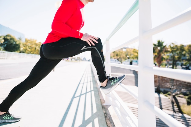 Free photo crop man exercising near fence