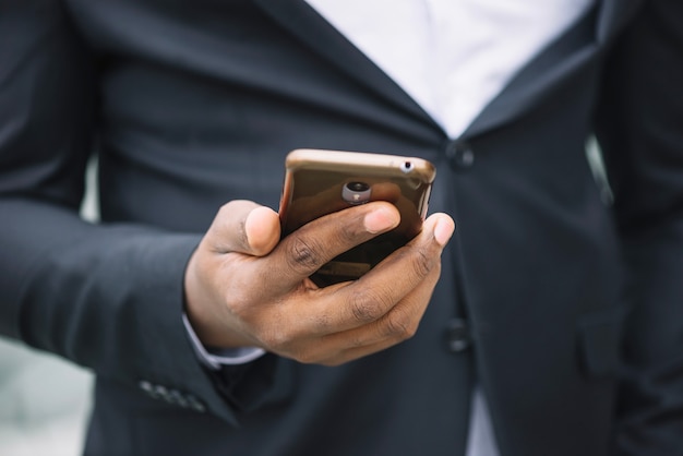 Free photo crop man holding smartphone