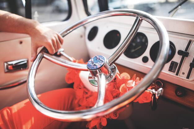 Crop man holding steering wheel