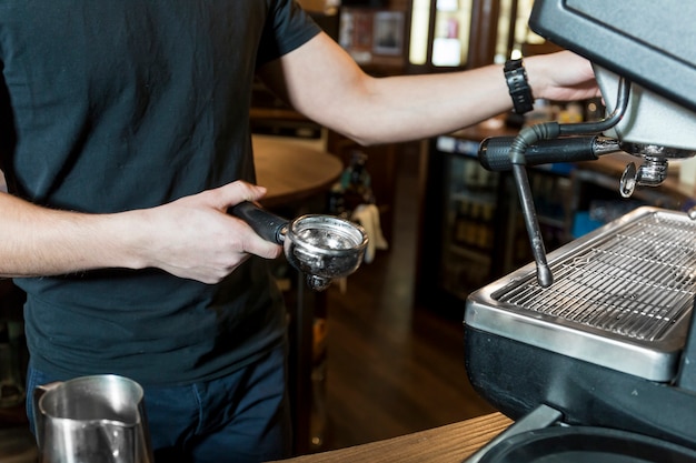 Free Photo crop man making coffee in cafe