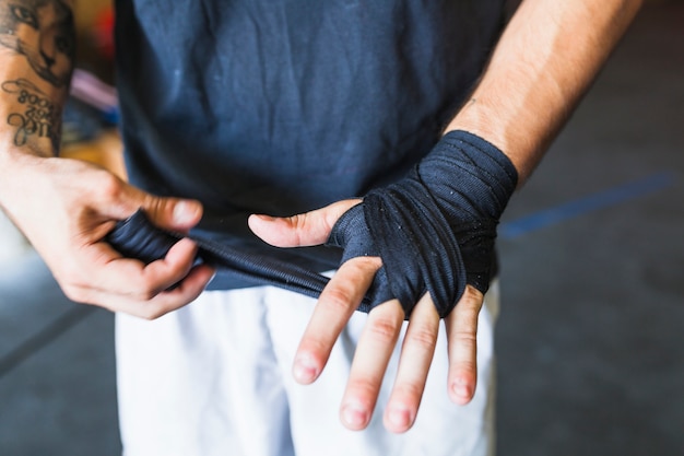 Free Photo crop man protecting hand with band