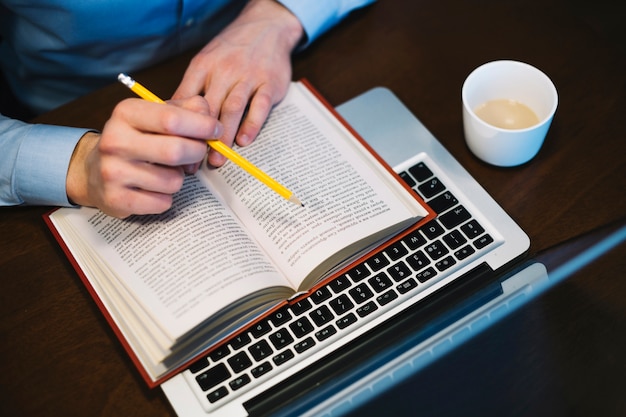 Free photo crop man studying near laptop