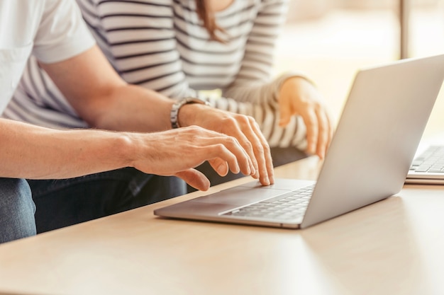 Crop man typing laptop