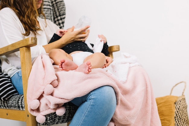 Crop mother feeding baby