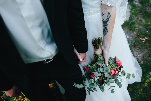 Free Photo crop newlyweds holding hands