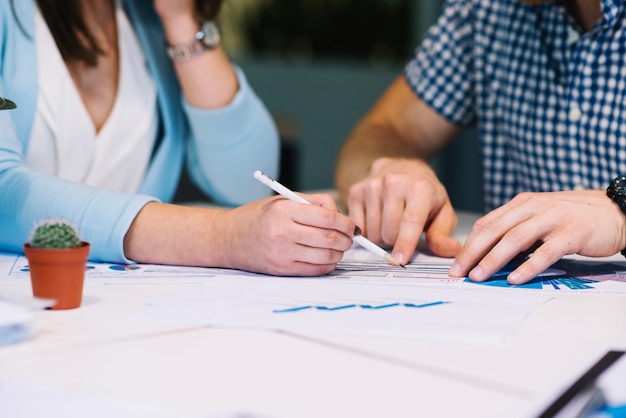 Crop people making notes on diagrams