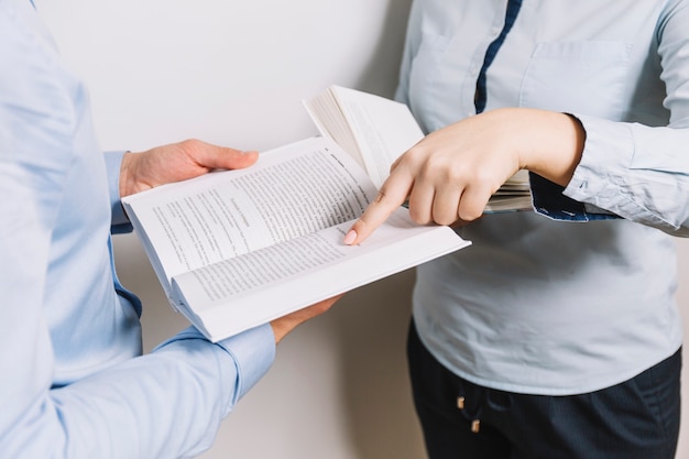 Crop people reading books