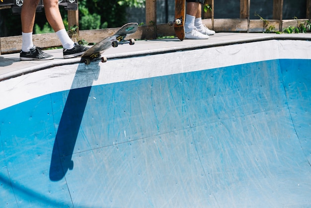 Crop people with skateboards