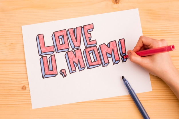 Free photo crop person drawing inscription love u mom