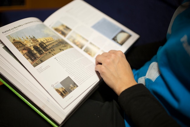 Crop person reading book