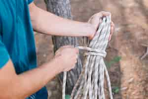 Free photo crop person tying rope