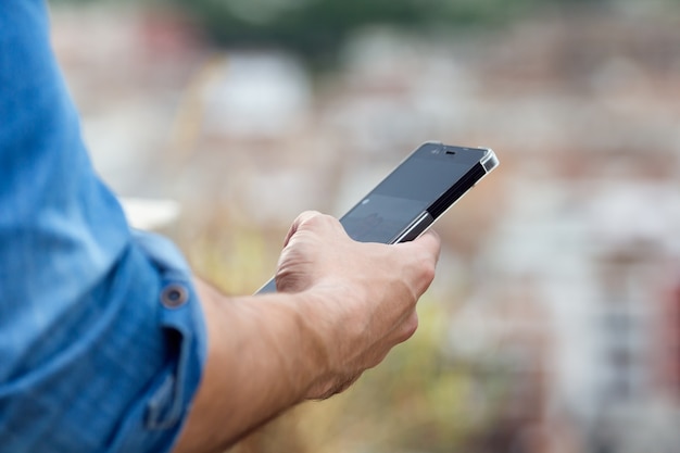 Crop photo of male hand with gadget