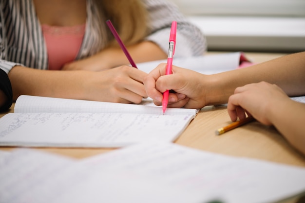 Crop students taking notes