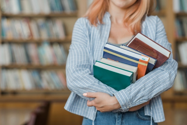 Free photo crop teenager hugging books