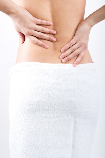 Crop topless female back covered with towel