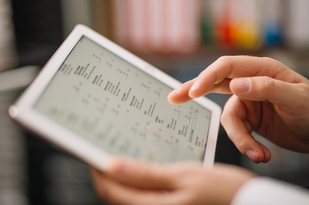 Crop unrecognizable worker with tablet