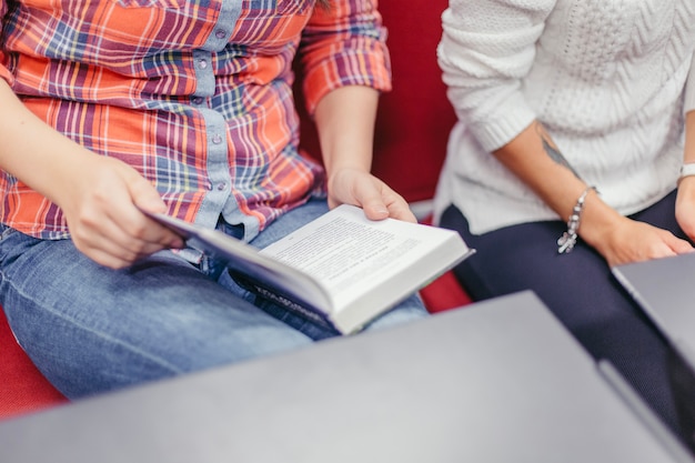 Free photo crop view of woman reading book