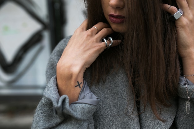 Free photo crop woman in accessories posing in coat