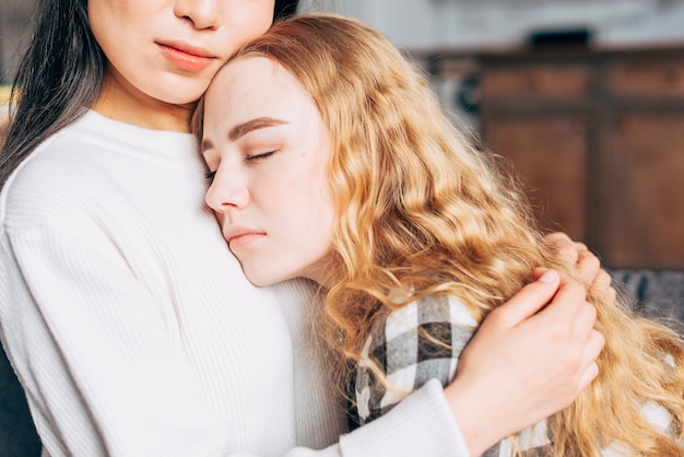 Crop woman comforting friend