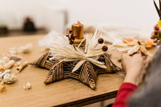 Crop woman crafting decoration