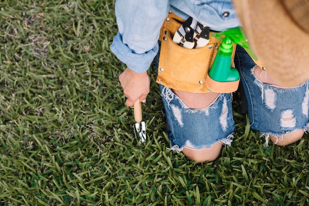 Free photo crop woman digging grass up