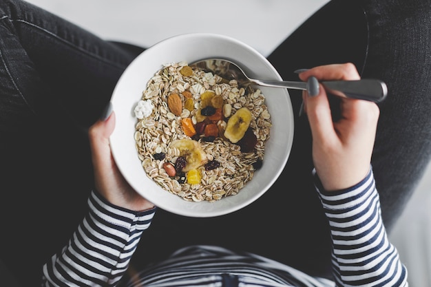 Free Photo crop woman eating muesli