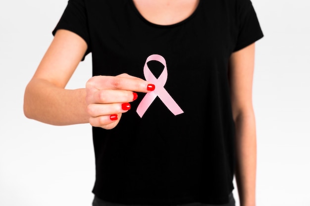 Free photo crop woman holding breast cancer ribbon