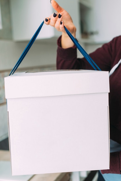 Free photo crop woman holding cake box