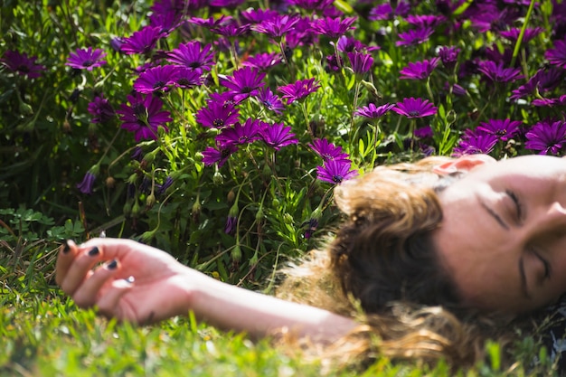 Free photo crop woman lying in garden