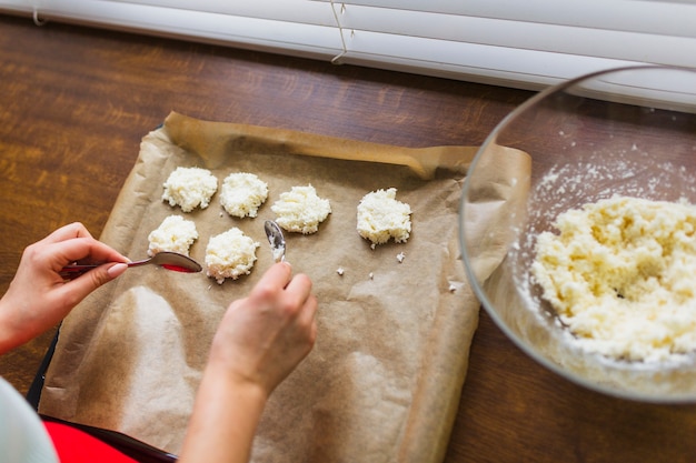 Crop woman making cookies