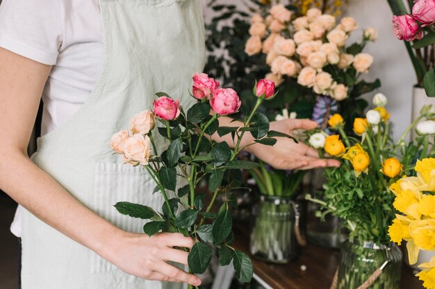 Crop woman near flowers