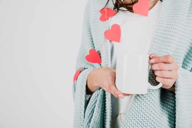 Free photo crop woman in plaid holding cup