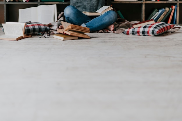 Free Photo crop woman reading on floor