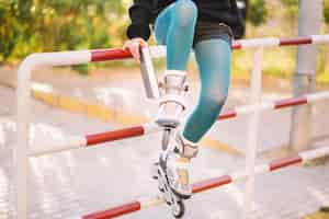 Free photo crop woman in roller skates holding book