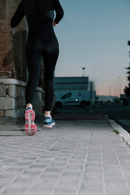 Free photo crop woman running on street