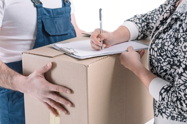 Free photo crop woman signing for parcel