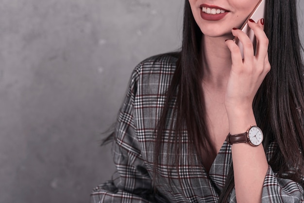 Free Photo crop woman speaking on smartphone