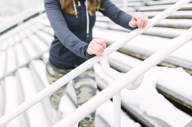 Free Photo crop woman training near railings