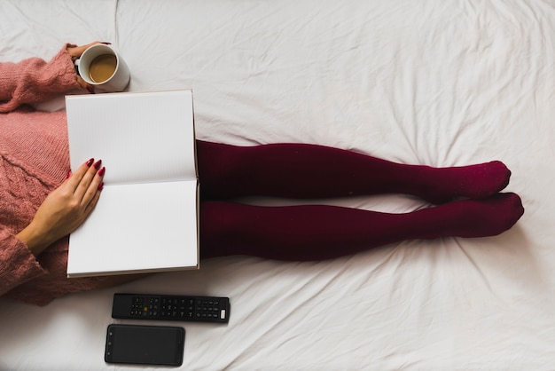 Free photo crop woman with coffee and notebook