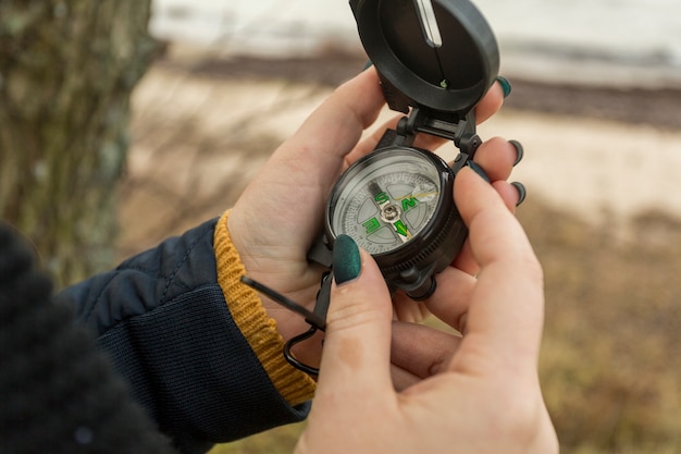 Crop woman with compass