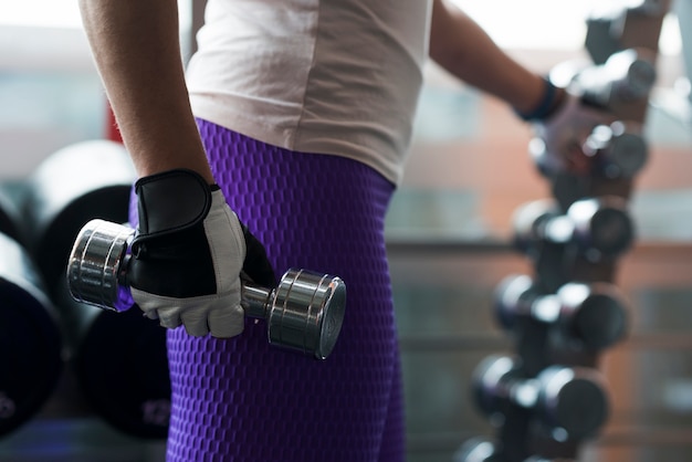 Free photo crop woman with dumbbell