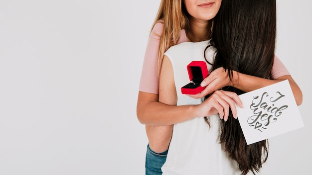 Free Photo crop woman with ring hugging girlfriend