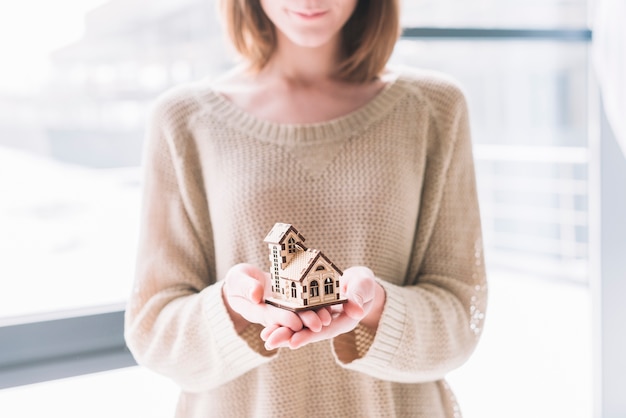 Free photo crop woman with small house