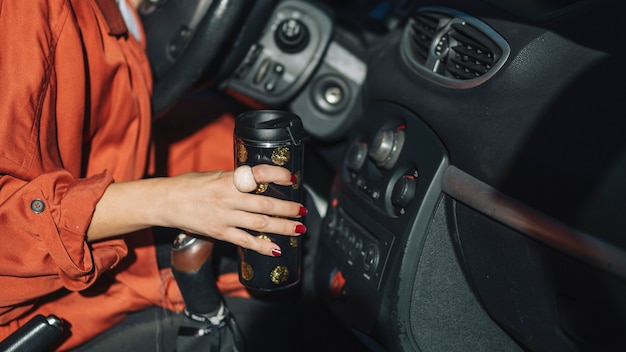 Free Photo crop woman with thermos in car