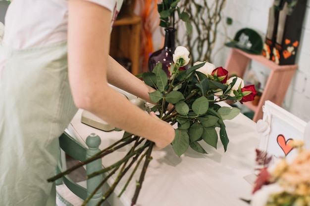 Crop worker composing roses