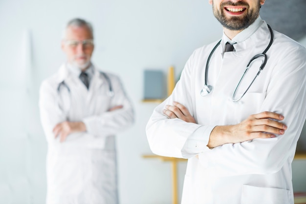 Free photo crop young doctor standing in office