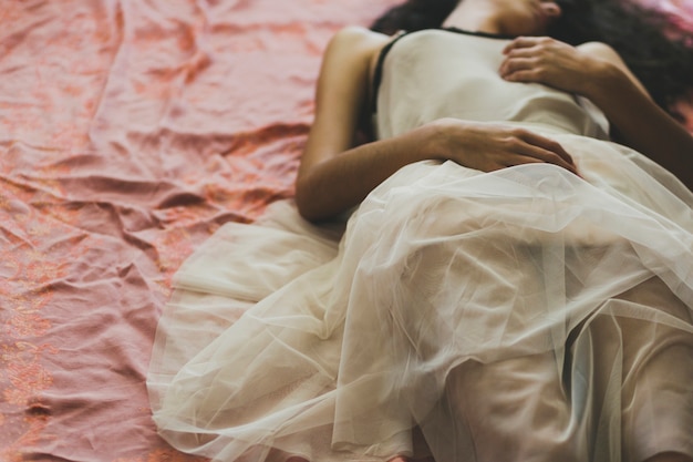 Free Photo crop young woman lying on floor