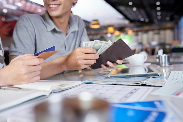 Cropped people checking their wallet for money and bank card