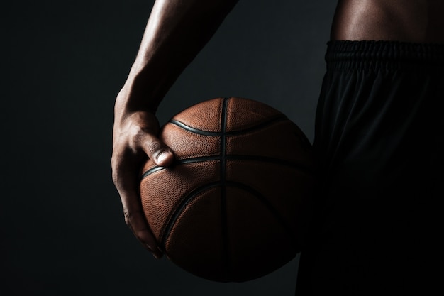 Cropped photo of basketball player holding ball