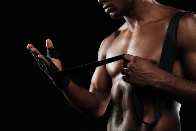 Free photo cropped photo of hands young afroamerican boxer, winds boxing bandages